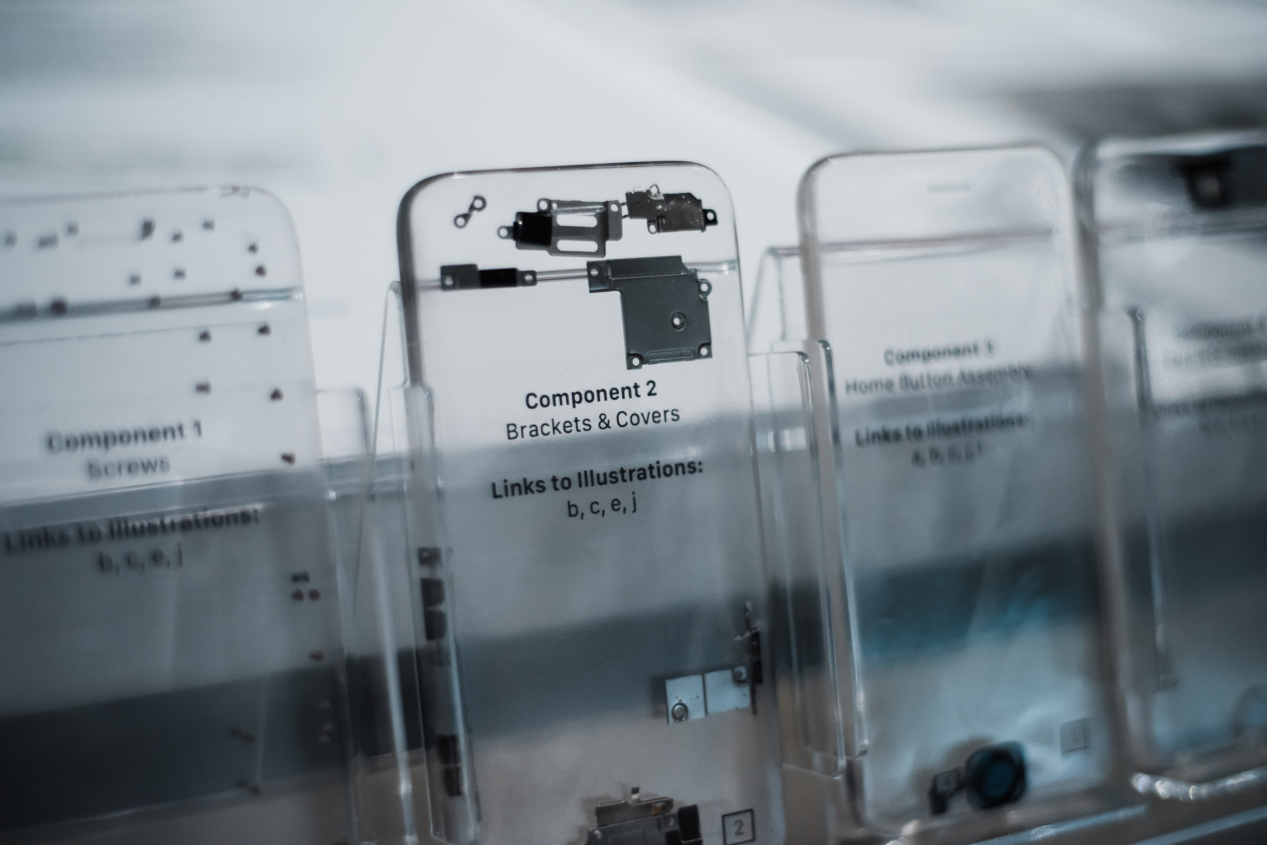 Photograph of deconstructed iPhones. Components suspended in resin.